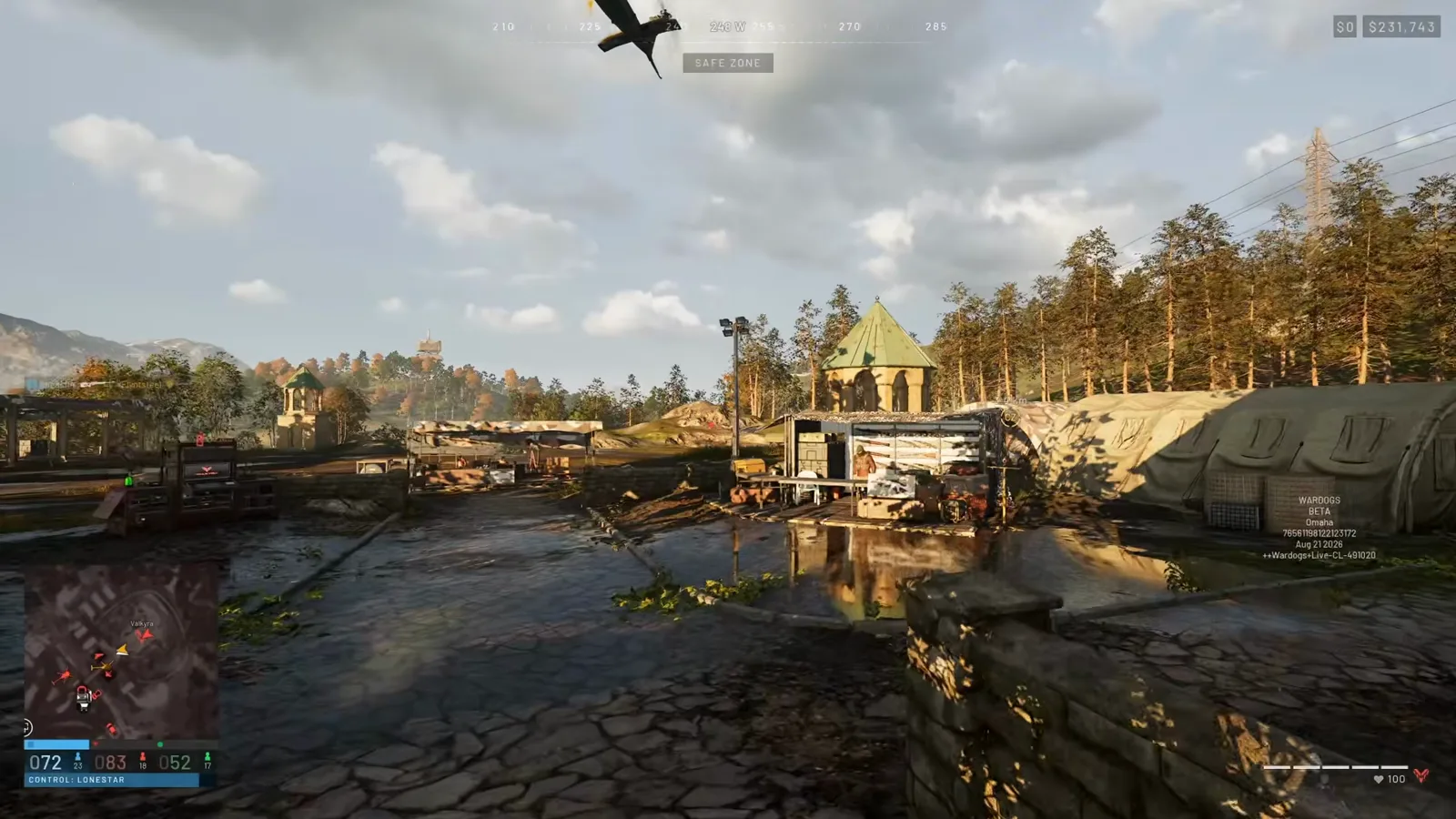 WARDOGS player overlooking an enemy FOB of camo-netted tents and a green-domed tower from a rocky hillside as a helicopter flies in overhead