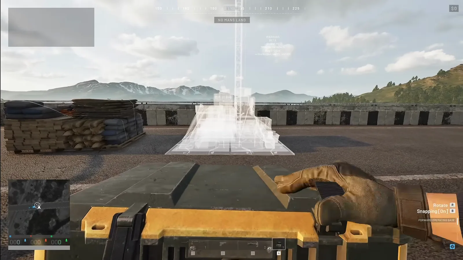 WARDOGS FOB placement hologram glowing white on an open road while the player holds the deploy device with Rotate and Snapping prompts on screen
