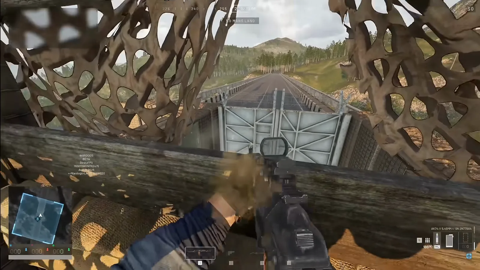 WARDOGS recon tower view looking through camouflage netting at a metal base gate on the bridge below during base building