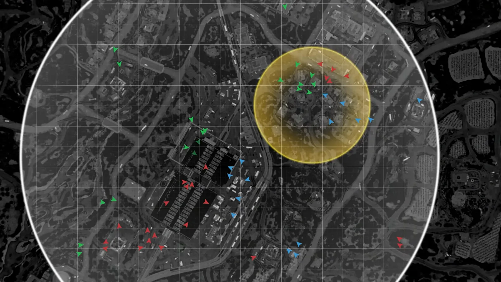 WARDOGS tactical map overlay showing the circular control zone with the yellow moving hot zone inside it and green, red, and blue markers for the three competing teams