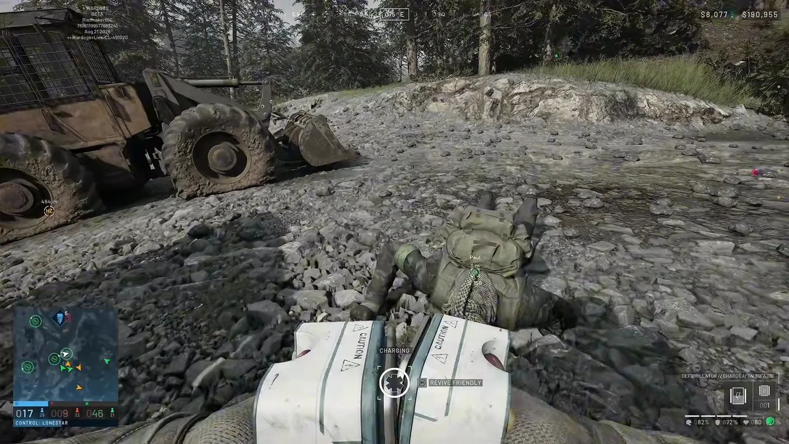 WARDOGS defibrillator held over a downed teammate marked Paul with a CHARGING meter and a REVIVE FRIENDLY prompt while the charge count reads 001