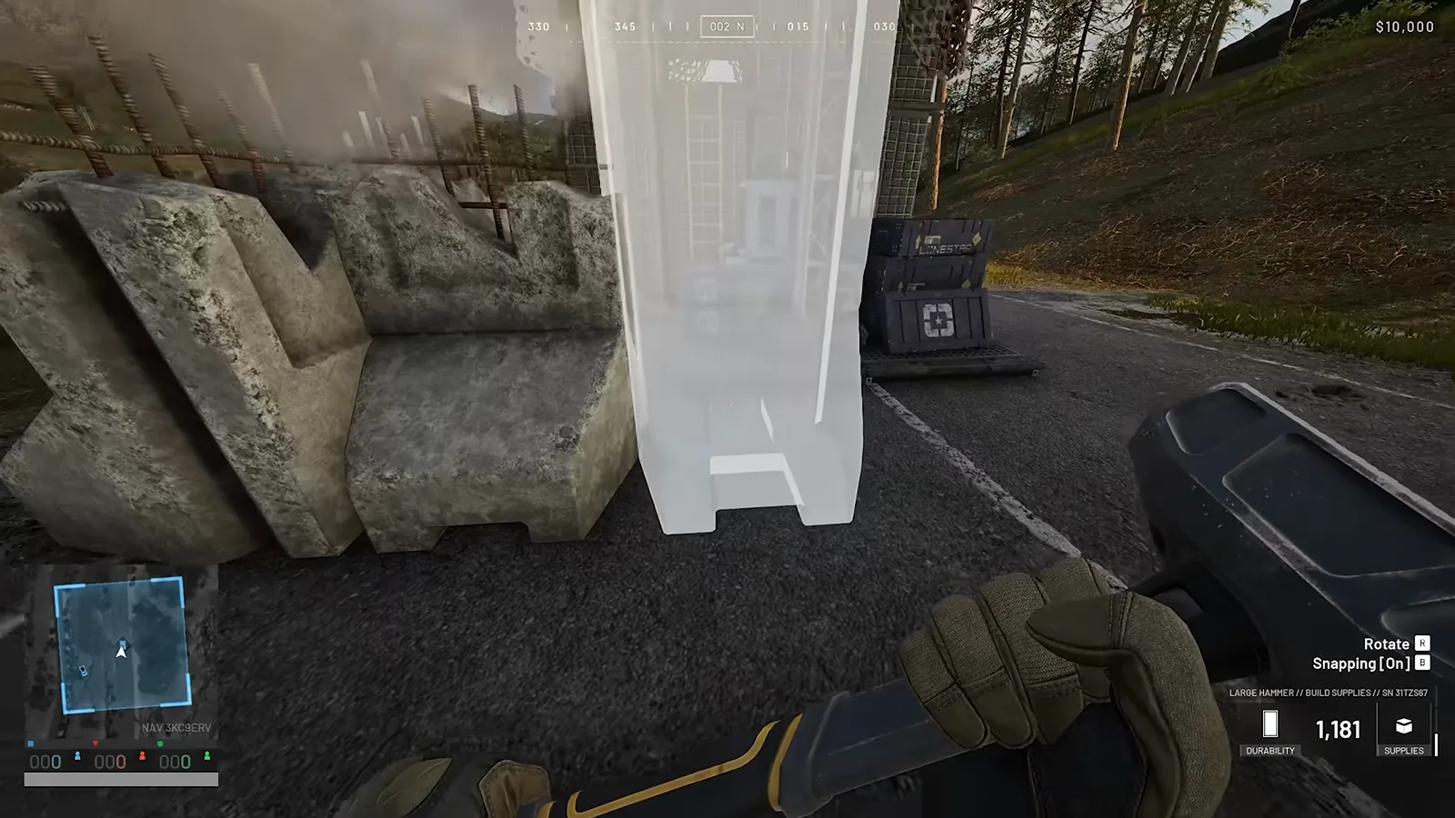 First-person view in WARDOGS showing Brimstone wall segments being hammered into an eight-block-high perimeter around a Recon Tower FOB with sloped faces pointing outward
